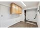 Functional utility room with wood-look floors and wall-mounted cabinets for storage at 2843 S Otis St, Denver, CO 80227
