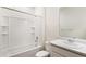 Well-lit bathroom with a shower-tub combo, vanity, and modern white fixtures at 27674 E Byers Ave, Aurora, CO 80018