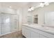 Bright bathroom features a double sink vanity, a glass-enclosed shower, and a neutral color palette at 27674 E Byers Ave, Aurora, CO 80018
