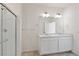 Bright bathroom features double sinks, a large mirror, and tiled floors at 27674 E Byers Ave, Aurora, CO 80018