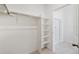 Spacious walk-in closet featuring neutral carpet, adjustable shelving, and ample storage at 27674 E Byers Ave, Aurora, CO 80018