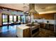 Modern community kitchen equipped with stainless steel appliances, island cooktop, and dining area at 27674 E Byers Ave, Aurora, CO 80018