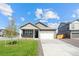 Lovely single-story home with a manicured lawn, stone accents, and a two-car garage on a sunny day at 27674 E Byers Ave, Aurora, CO 80018