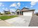 Inviting single-Gathering home with a well-maintained lawn, driveway, and an attached two-car garage at 27674 E Byers Ave, Aurora, CO 80018