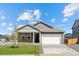 Charming single-story home featuring a well-manicured lawn, stone accents, and an attached two-car garage at 27674 E Byers Ave, Aurora, CO 80018