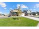 Beautiful home showcasing lush green lawn and professional landscaping under a bright, cloudy sky at 27674 E Byers Ave, Aurora, CO 80018
