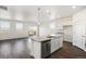 Open floorplan with kitchen island overlooking a living area and walkout deck at 27674 E Byers Ave, Aurora, CO 80018