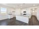Open kitchen with white cabinets, granite countertops, and stainless steel appliances at 27674 E Byers Ave, Aurora, CO 80018