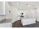 Modern kitchen with sleek white cabinets, granite countertops, and stainless appliances at 27674 E Byers Ave, Aurora, CO 80018