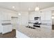 Modern kitchen with white cabinets, granite countertops, and stainless steel appliances at 27674 E Byers Ave, Aurora, CO 80018