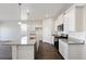 Well-lit kitchen with granite counters, island, stainless appliances, and sleek white cabinetry at 27674 E Byers Ave, Aurora, CO 80018