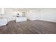 Expansive living room merging into a kitchen, complete with elegant gray wood floors and a bright, airy feel at 27674 E Byers Ave, Aurora, CO 80018