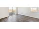 Bright living room featuring hardwood floors and a sliding glass door to a deck at 27674 E Byers Ave, Aurora, CO 80018