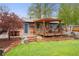 Backyard with a patio, pergola, and lush lawn, creating an inviting outdoor living space at 6742 Marshall St, Arvada, CO 80003