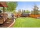Backyard featuring a pergola, storage shed, and trampoline, perfect for outdoor activities at 6742 Marshall St, Arvada, CO 80003