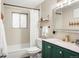 Bathroom featuring a bathtub, shower, modern vanity and window at 6742 Marshall St, Arvada, CO 80003