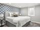 Bedroom featuring a decorative accent wall, plush bed, and natural light from the window at 6742 Marshall St, Arvada, CO 80003