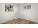 Bedroom with hardwood floors and natural light coming through two windows at 6742 Marshall St, Arvada, CO 80003