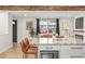 Open-concept kitchen with granite counters, stainless appliances, and seating, connecting to the living area at 6742 Marshall St, Arvada, CO 80003