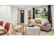 Comfortable living room with natural light, a cozy sofa, modern decor, and a view to the exterior at 6742 Marshall St, Arvada, CO 80003