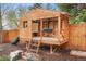 Charming wooden playhouse with a slide and platform, perfect for outdoor fun at 6742 Marshall St, Arvada, CO 80003