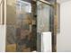 Shower with glass door, slate tile walls, a built-in niche and chrome hardware at 6742 Marshall St, Arvada, CO 80003