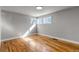 Bright bedroom featuring hardwood floors, neutral walls, and natural light from multiple windows at 10025 W 8Th Ave, Lakewood, CO 80215