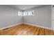 Bright bedroom with hardwood floors, large windows, and neutral paint, offering a blank canvas at 10025 W 8Th Ave, Lakewood, CO 80215