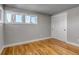 Bedroom boasts hardwood floors, a closet with sliding doors, and is lit by natural light from the windows at 10025 W 8Th Ave, Lakewood, CO 80215