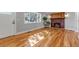 Spacious living room with hardwood floors, brick fireplace, large windows and door at 10025 W 8Th Ave, Lakewood, CO 80215