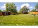 Spacious backyard with lush green grass, a storage shed, and a privacy fence at 885 Balsam St, Lakewood, CO 80214