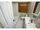 Bright bathroom with a tiled shower-tub, vanity, and toilet at 885 Balsam St, Lakewood, CO 80214