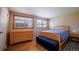 Bedroom featuring hardwood floors, neutral walls, and natural light from two windows at 885 Balsam St, Lakewood, CO 80214