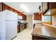 Well-equipped kitchen features stainless steel appliances and rich wood cabinets at 885 Balsam St, Lakewood, CO 80214