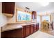 Well-lit kitchen features ample cabinet space, a large window, and views of the dining area at 885 Balsam St, Lakewood, CO 80214