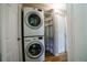 Convenient laundry area features a stacked washer and dryer and metal storage shelving for organization at 885 Balsam St, Lakewood, CO 80214