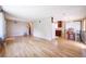 Open-concept living and dining area featuring gleaming hardwood floors and abundant natural light at 885 Balsam St, Lakewood, CO 80214