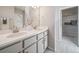 Stylish bathroom featuring a double vanity, modern lighting, and a walk-in closet at 22083 E 38Th Pl, Aurora, CO 80019