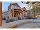 Expansive backyard patio with stone accents, wood pergola, and lush landscaping, perfect for outdoor entertaining at 14582 Homestead Pl, Broomfield, CO 80023