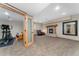 Spacious carpeted basement featuring a fireplace and workout equipment at 14582 Homestead Pl, Broomfield, CO 80023