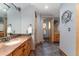 Stylish bathroom with dual sinks, granite countertops, and wood accents at 14582 Homestead Pl, Broomfield, CO 80023