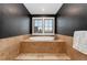 Contemporary bathroom with a soaking tub and tile surround at 14582 Homestead Pl, Broomfield, CO 80023
