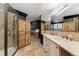 A contemporary bathroom with a shower, double vanity, and a large mirror at 14582 Homestead Pl, Broomfield, CO 80023