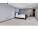 Spacious bedroom with neutral carpet, blue walls, recessed lighting, and an attached bathroom at 14582 Homestead Pl, Broomfield, CO 80023