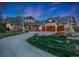 Inviting two-story home featuring a large circular driveway, lush landscaping, and a spacious three-car garage at 14582 Homestead Pl, Broomfield, CO 80023