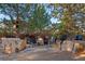 Inviting backyard fire pit with comfortable seating, nestled among mature trees for a cozy outdoor gathering space at 14582 Homestead Pl, Broomfield, CO 80023