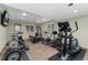 Bright home gym featuring weights, stationary bikes, and an elliptical at 14582 Homestead Pl, Broomfield, CO 80023