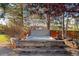 Backyard hot tub with stone steps and mature trees, perfect for relaxing and unwinding at 14582 Homestead Pl, Broomfield, CO 80023