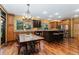 Gourmet kitchen featuring an island, granite countertops, custom cabinets, and hardwood floors at 14582 Homestead Pl, Broomfield, CO 80023