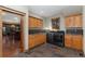 Well-lit laundry room featuring wood cabinets, modern washer and dryer, and tile backsplash at 14582 Homestead Pl, Broomfield, CO 80023